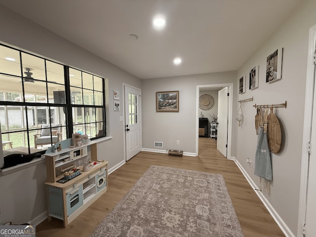 foyer entrance featuring light wood-style flooring, baseboards, and recessed lighting