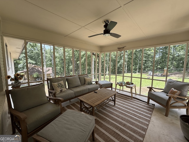 sunroom / solarium with an outdoor living space, healthy amount of natural light, and a ceiling fan