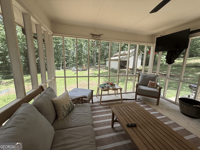 sunroom with ceiling fan, an outdoor living space, and healthy amount of natural light