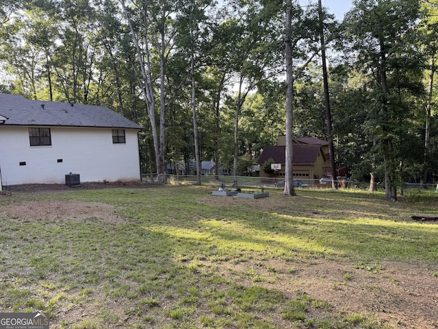 view of yard featuring cooling unit and view of scattered trees