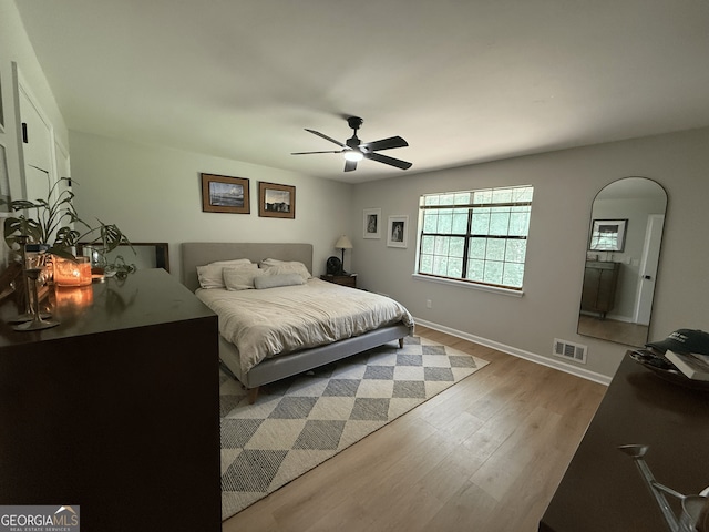 bedroom featuring wood finished floors, baseboards, and a ceiling fan