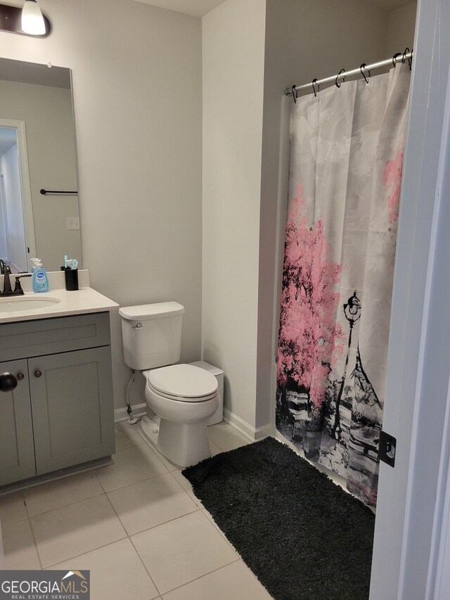 436 Lothbury Ave, Locust Grove, GA 30248 - bathroom with tile patterned floors, toilet, vanity, and a shower with shower curtain