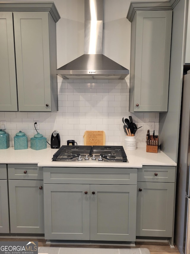 436 Lothbury Ave, Locust Grove, GA 30248 - kitchen featuring wall chimney exhaust hood, gray cabinets, stainless steel appliances, backsplash, and light countertops