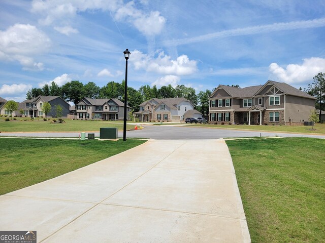 436 Lothbury Ave, Locust Grove, GA 30248 - view of concrete surface with a residential view and street lighting