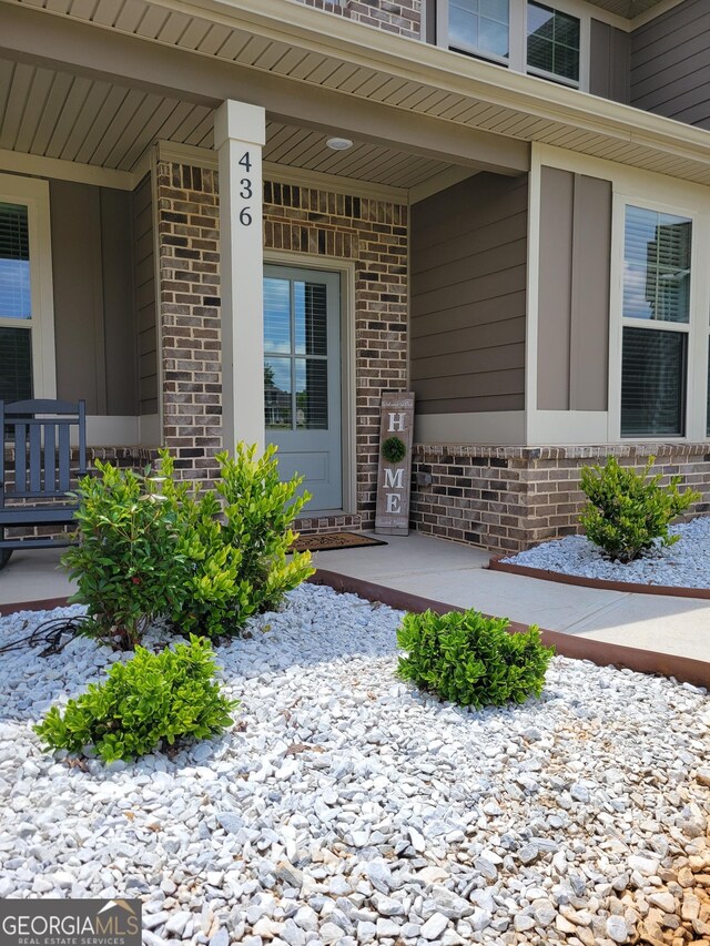 436 Lothbury Ave, Locust Grove, GA 30248 - view of exterior entry featuring brick siding and a porch