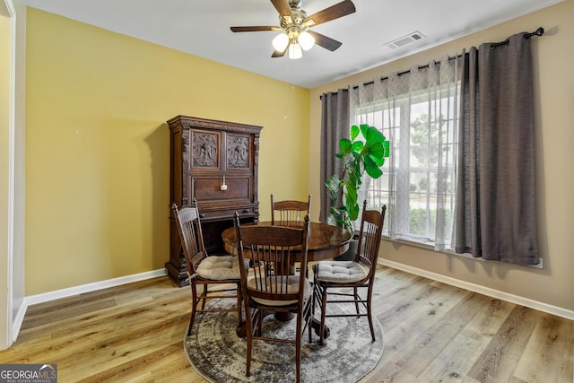 733 Firefly Ct, Griffin, GA 30223 - dining area with a ceiling fan, baseboards, and light wood finished floors