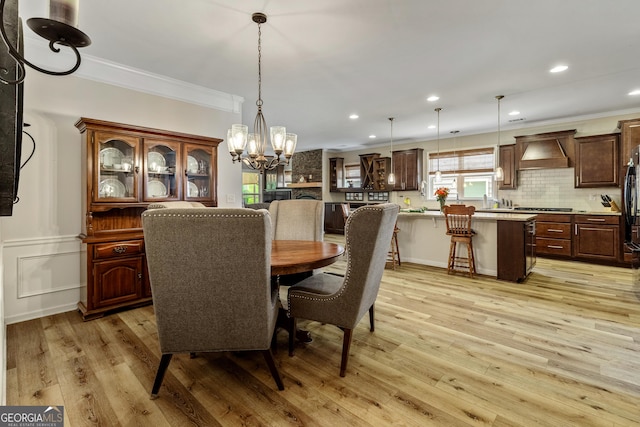 733 Firefly Ct, Griffin, GA 30223 - dining space featuring crown molding, a chandelier, light wood-style floors, recessed lighting, and wainscoting