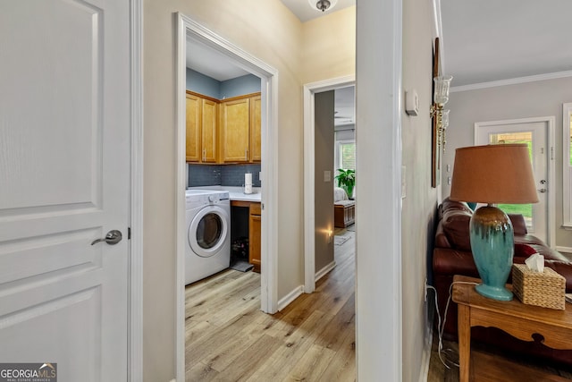 733 Firefly Ct, Griffin, GA 30223 - laundry room featuring washer / clothes dryer, cabinet space, light wood-type flooring, and crown molding