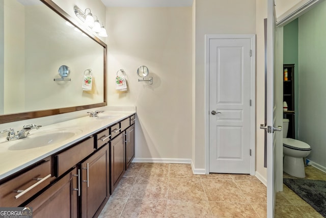 733 Firefly Ct, Griffin, GA 30223 - full bathroom featuring double vanity, toilet, baseboards, and tile patterned flooring