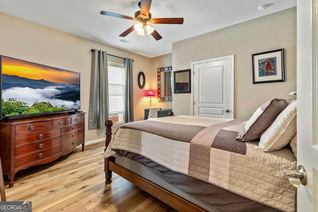 733 Firefly Ct, Griffin, GA 30223 - bedroom with light wood-style floors, ceiling fan, and baseboards