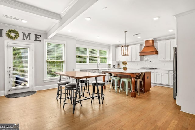 3298 Alcovy Club Ct, Dacula, GA 30019 - dining room featuring ornamental molding, light wood finished floors, beamed ceiling, recessed lighting, and baseboards