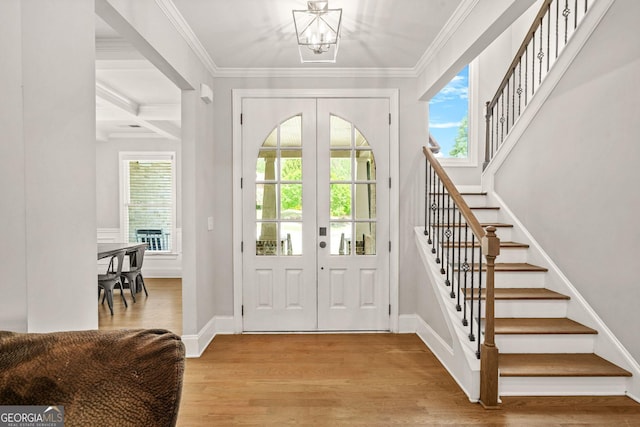 3298 Alcovy Club Ct, Dacula, GA 30019 - foyer entrance featuring stairs, light wood finished floors, a chandelier, french doors, and crown molding