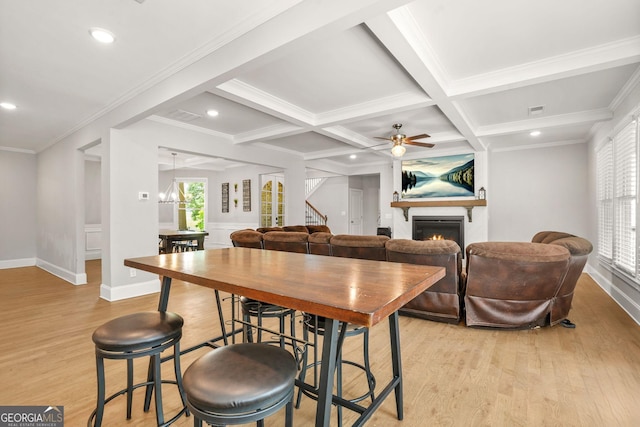 3298 Alcovy Club Ct, Dacula, GA 30019 - dining area with a glass covered fireplace, light wood-type flooring, stairs, a ceiling fan, and recessed lighting
