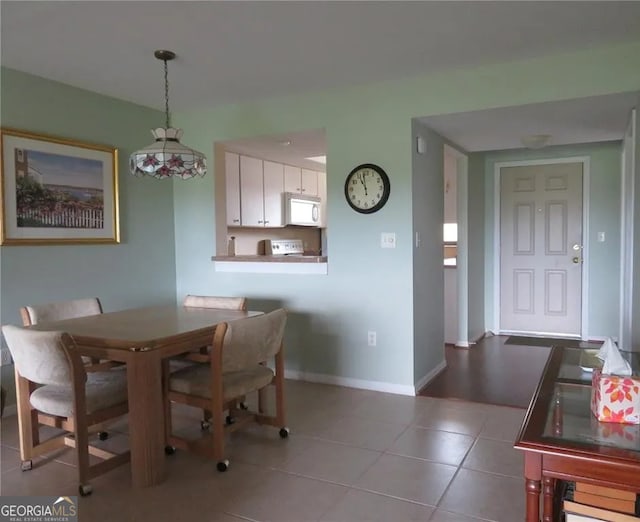 26461 Explorer Rd Unit A, Punta Gorda, FL 33983 - tiled dining space featuring baseboards