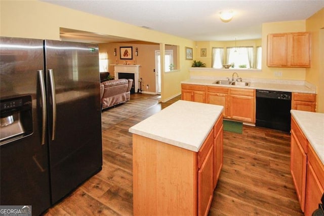 kitchen featuring stainless steel refrigerator with ice dispenser, dishwasher, dark wood-style floors, a sink, and a kitchen island