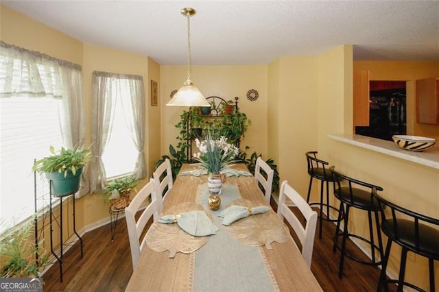 dining area with wood finished floors and baseboards