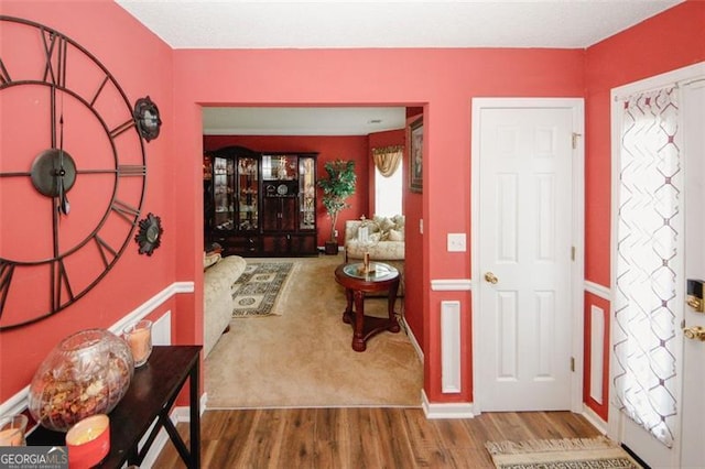 entryway with wood finished floors
