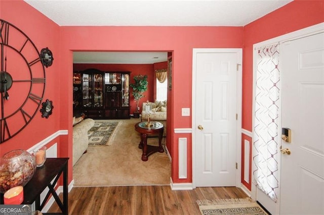entrance foyer featuring wood finished floors and baseboards