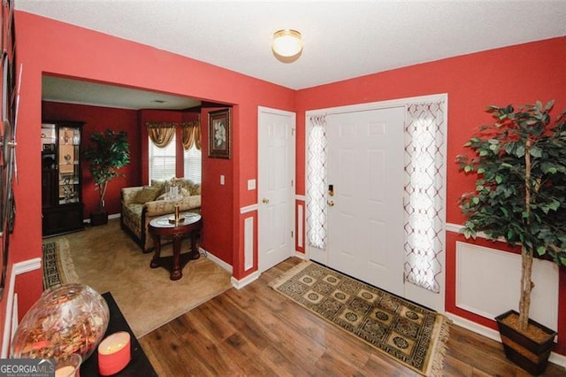 entrance foyer with wood finished floors and baseboards