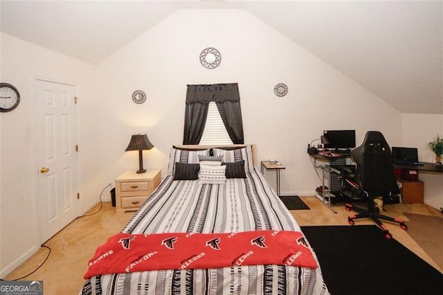 carpeted bedroom with vaulted ceiling, a desk, and baseboards