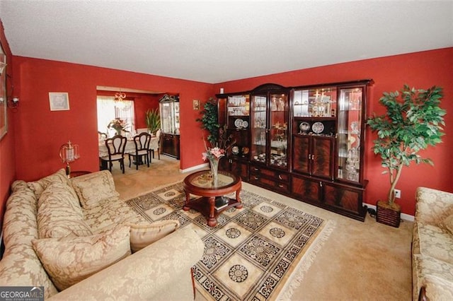 living area featuring carpet flooring and baseboards