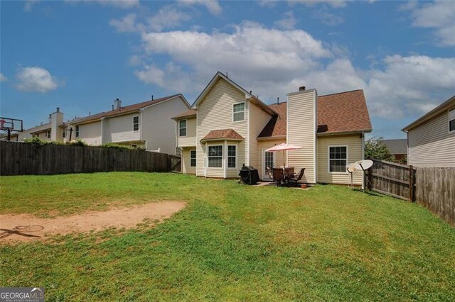 back of property with a chimney and a shingled roof