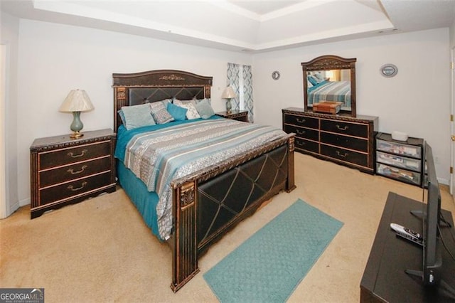 bedroom with a raised ceiling, carpet flooring, and baseboards