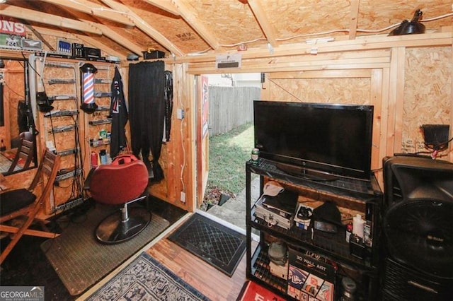 miscellaneous room with vaulted ceiling and wood finished floors