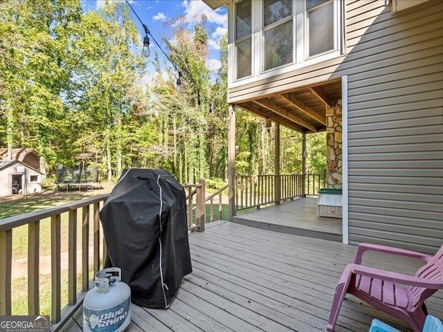 665 Mcclain Mountain Rd, Jasper, GA 30143 - wooden terrace featuring a trampoline and area for grilling