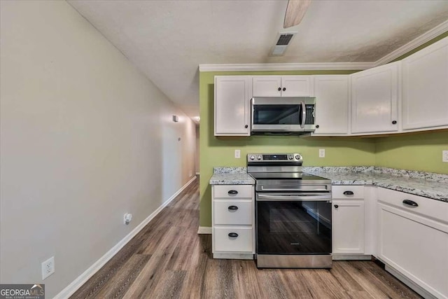 kitchen with stainless steel appliances, dark wood-style flooring, white cabinetry, and baseboards