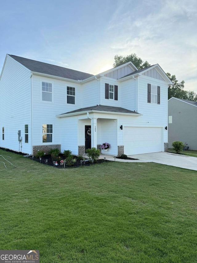 189 Bentwater Way, Hoschton, GA 30548 - view of front of property featuring a garage, board and batten siding, driveway, and a front lawn