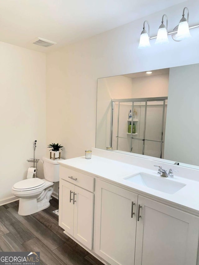 189 Bentwater Way, Hoschton, GA 30548 - bathroom featuring vanity, a shower stall, and wood finished floors
