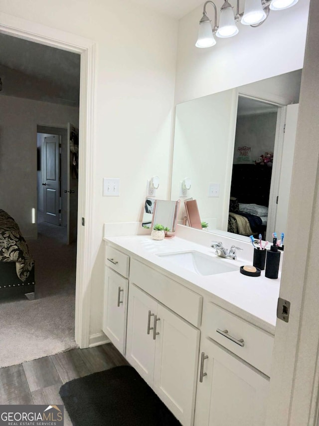 189 Bentwater Way, Hoschton, GA 30548 - ensuite bathroom with vanity and wood finished floors