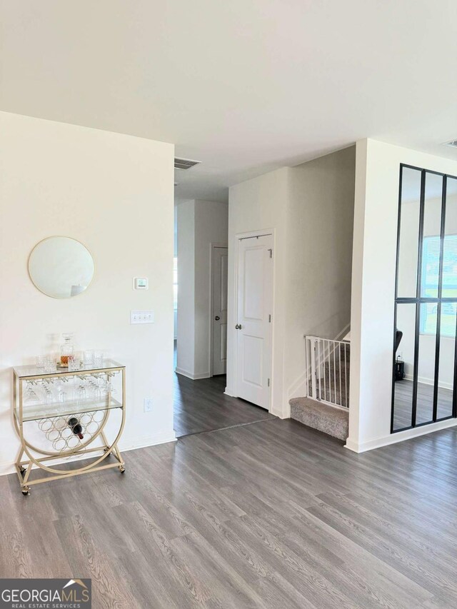 189 Bentwater Way, Hoschton, GA 30548 - spare room with wood finished floors and stairway