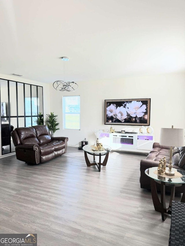 189 Bentwater Way, Hoschton, GA 30548 - living area with wood finished floors and a chandelier
