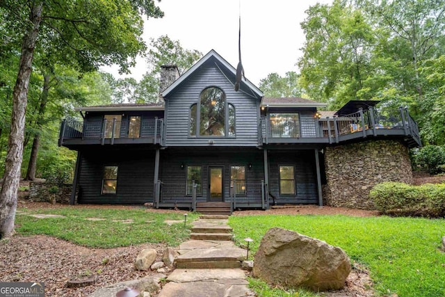 1560 Parks Mill Dr, Greensboro, GA 30642 - view of front of home featuring a balcony, a front lawn, a chimney, and stone siding