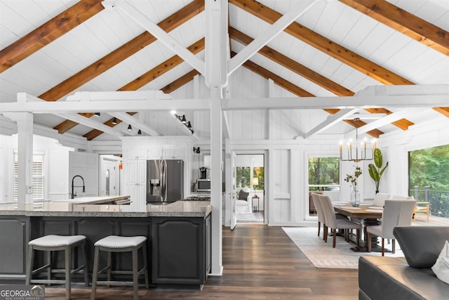 1560 Parks Mill Dr, Greensboro, GA 30642 - kitchen featuring stainless steel refrigerator with ice dispenser, dark wood finished floors, light stone countertops, wooden ceiling with exposed beams, and a sink
