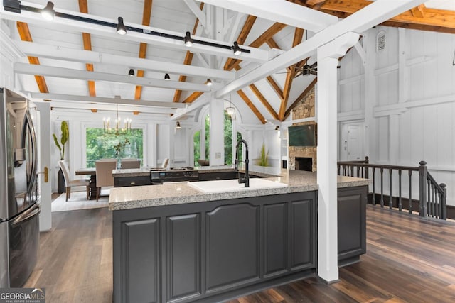 1560 Parks Mill Dr, Greensboro, GA 30642 - kitchen featuring stainless steel fridge with ice dispenser, a sink, a ceiling fan, a stone fireplace, and an island with sink
