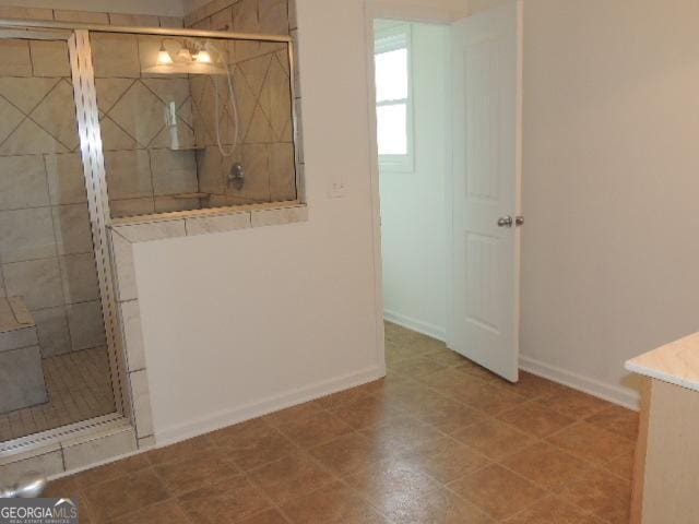 full bath with walk in shower and baseboards