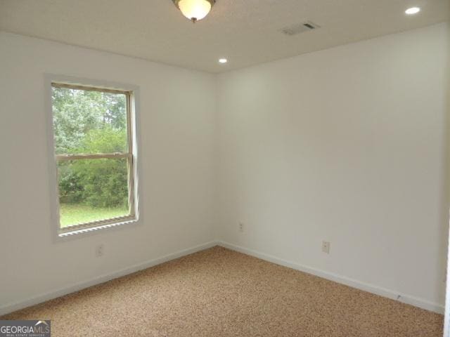 carpeted spare room featuring recessed lighting and baseboards