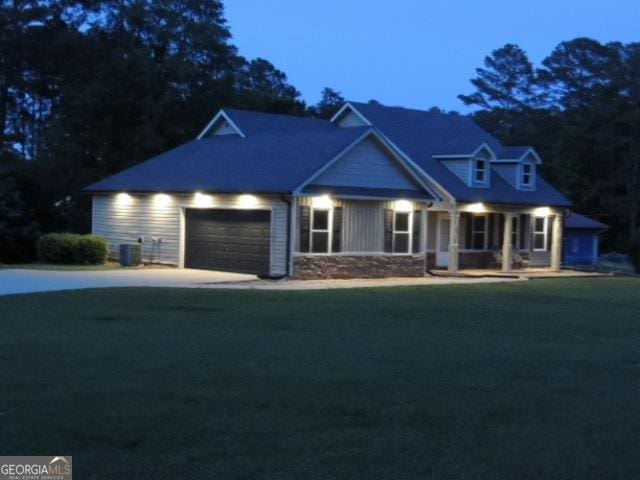 view of front of property featuring a garage, a porch, and concrete driveway