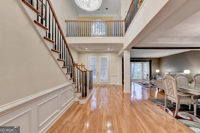 3565 Hickory Branch Trl, Suwanee, GA 30024 - foyer entrance featuring a chandelier, stairs, wood finished floors, crown molding, and a decorative wall