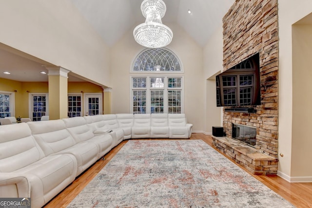 3565 Hickory Branch Trl, Suwanee, GA 30024 - living area featuring a fireplace, wood finished floors, a chandelier, high vaulted ceiling, and recessed lighting