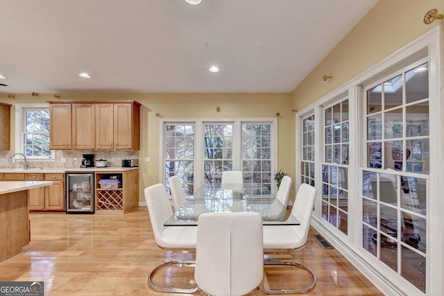 3565 Hickory Branch Trl, Suwanee, GA 30024 - dining space with beverage cooler, light wood-style flooring, and recessed lighting