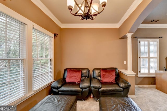 3565 Hickory Branch Trl, Suwanee, GA 30024 - living room with decorative columns, plenty of natural light, a chandelier, carpet, and crown molding