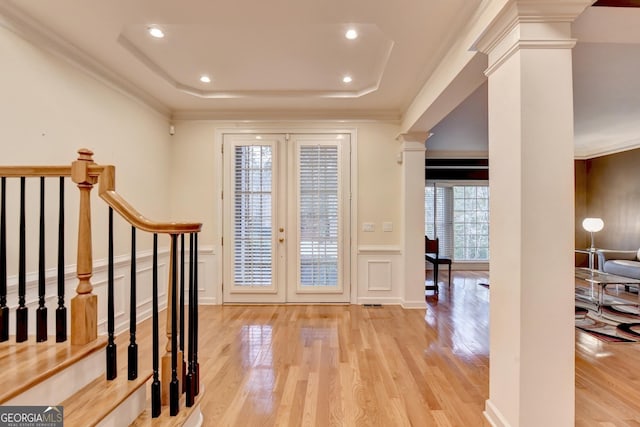 3565 Hickory Branch Trl, Suwanee, GA 30024 - foyer featuring ornate columns, wood finished floors, a decorative wall, a raised ceiling, and crown molding