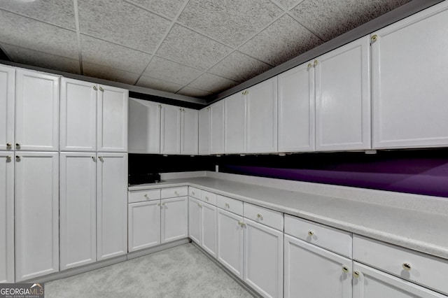 3565 Hickory Branch Trl, Suwanee, GA 30024 - kitchen with white cabinetry, light carpet, light countertops, and a paneled ceiling