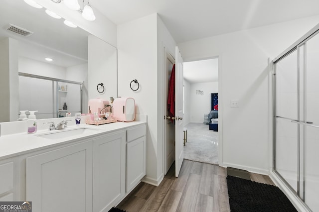 55 Knightsbridge Ln, Winder, GA 30680 - ensuite bathroom with wood finished floors, a stall shower, and vanity