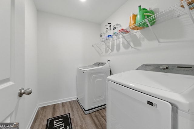 55 Knightsbridge Ln, Winder, GA 30680 - laundry area with washer and clothes dryer, wood finished floors, and baseboards