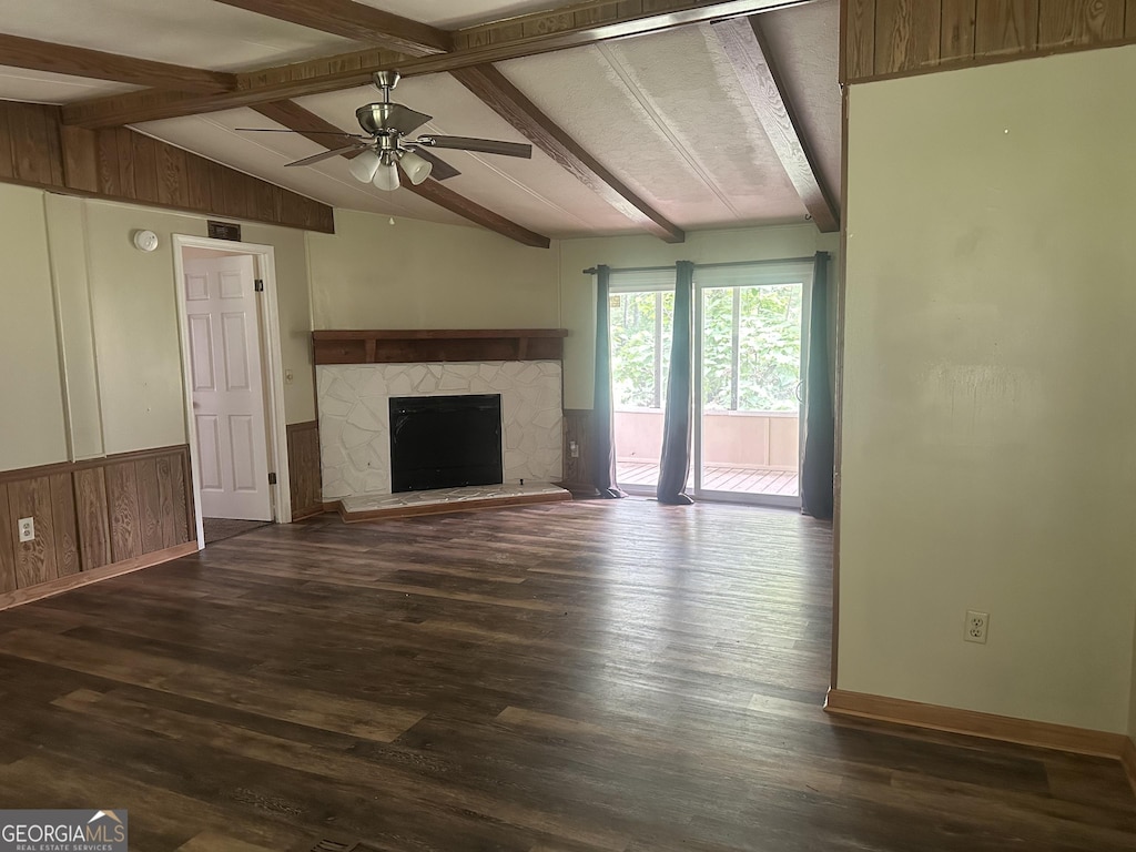 710 Seals Rd, Dallas, GA 30157 - unfurnished living room featuring ceiling fan, a fireplace with raised hearth, wood finished floors, baseboards, and a wainscoted wall
